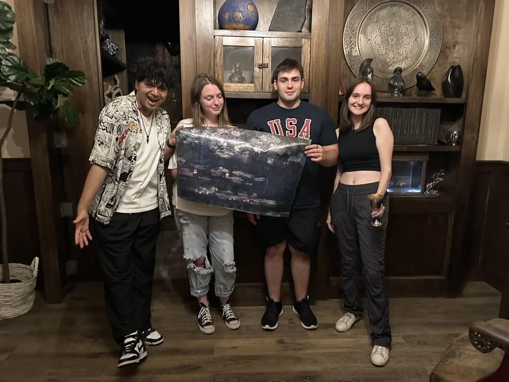Shubhankar and friends holding up a map after escaping a room