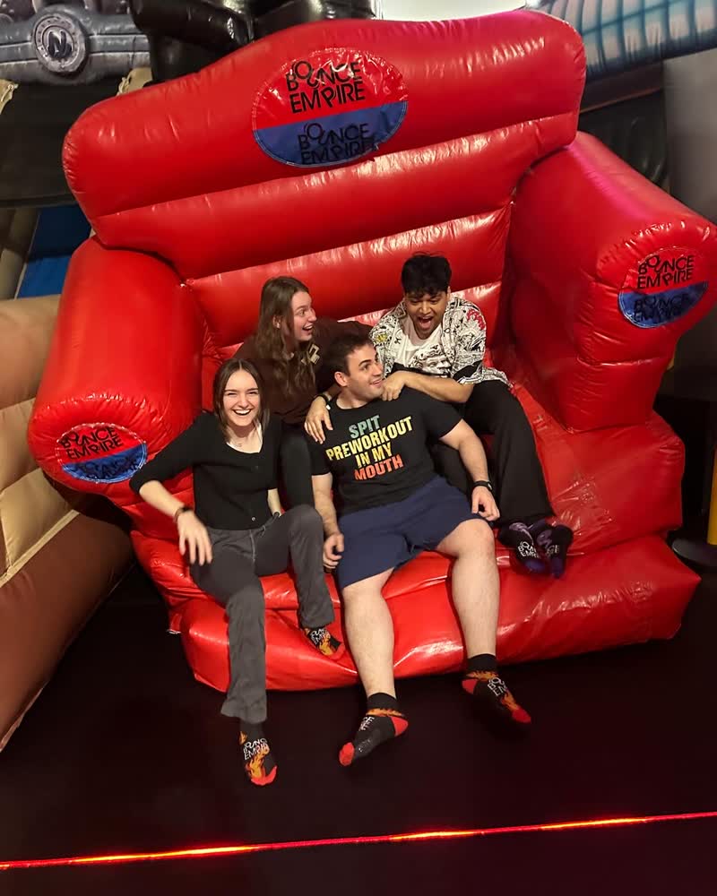 Shubhankar with Anna, Breno and Taryn on a giant red inflatable chair