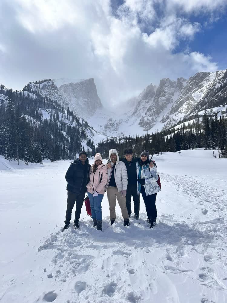 Shubhankar and friends in the snow below the peaks of Rocky Mountain National Park