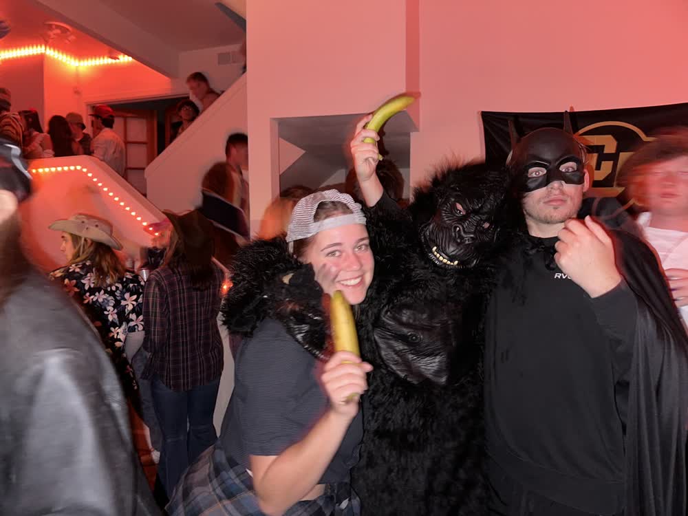 Shubhankar in a gorilla costume at a Halloween party, with friends holding bananas